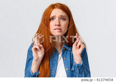 Close-up portrait nervous cute and hopeful caucasian redhead woman begging god for dream come true, cross fingers good luck, bite lip worried, praying over white background Close-up portrait nervous cute and hopeful caucasian redhead woman begging god for dream come true, cross fingers good luck, bite lip worried, praying over white background 61374658