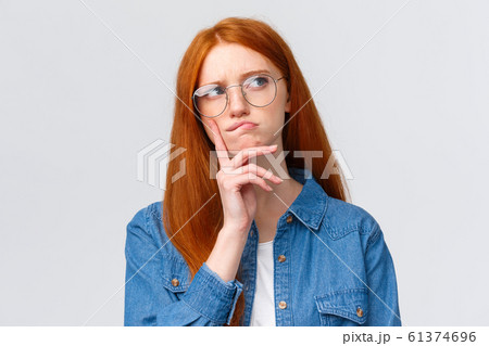 Close-up thoughtful and focused, creative female freelancer, student want work part-time, thinking opportunities, look away smirk and frowning pondering, make decision, stand white background 61374696