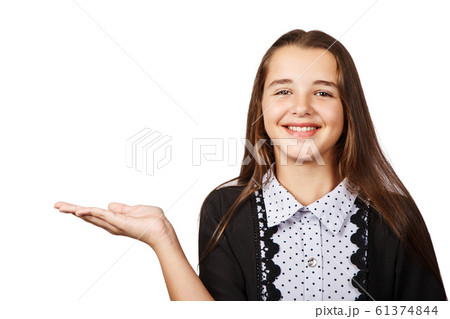 surprised teen girl showing a product surprised teen girl showing a product 61374844