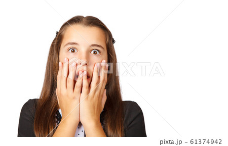 scared teen girl covering her mouth with hands 61374942