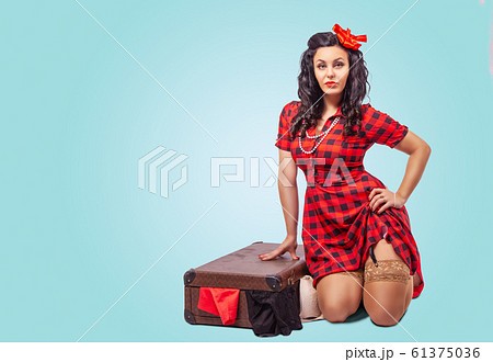 young woman sitting on the floor and putting young woman sitting on the floor and putting 61375036