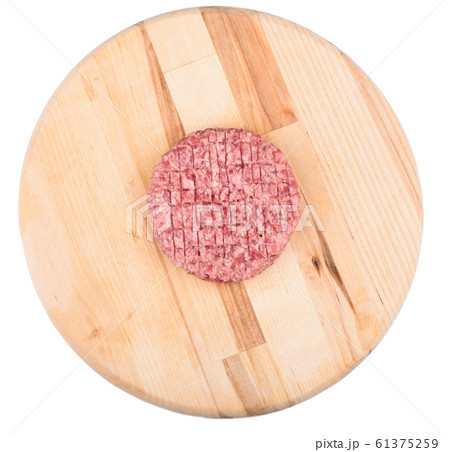 Raw pink beef cutlet isolated on a cutting board. 61375259