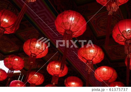 Many illuminated red Chinese lanterns with some Chinese characters on it Many illuminated red Chinese lanterns with some Chinese characters on it 61375737