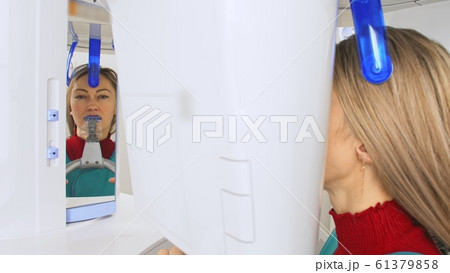Doctor to take a image 3dx-ray machine 3d digital scanner tomography of teeth and jaw in modern laoratory dental clinic. Computer dental diagnostics. 61379858