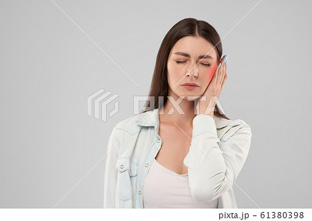 Woman showing earache. Woman showing earache. 61380398