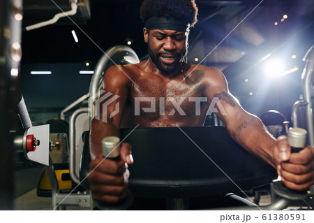 Athletic Man Exercising In Gym 61380591