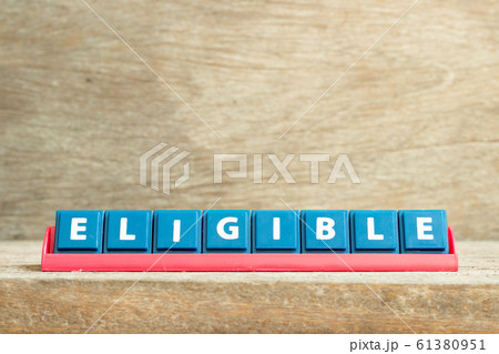 Tile letter on red rack in word eligible on wood background 61380951