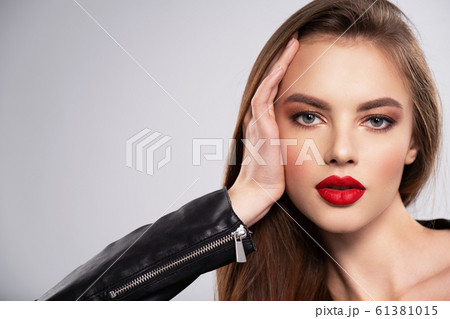 Portrait of beautiful young woman with bright 61381015
