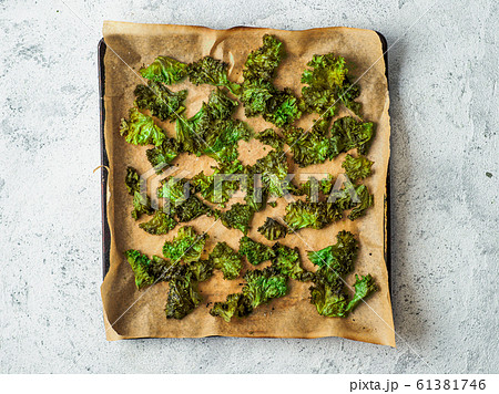 Kale Chips with salt on oven-tray, top view Kale Chips with salt on oven-tray, top view 61381746