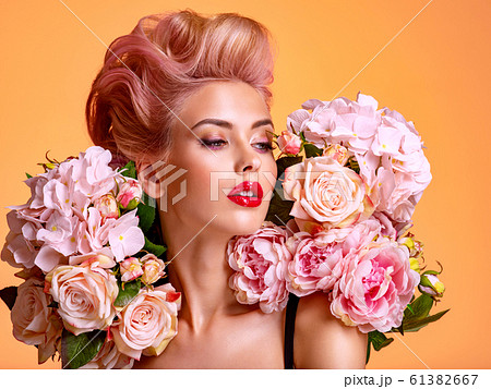 Beautiful white girl with flowers. Stunning blonde Beautiful white girl with flowers. Stunning blonde 61382667