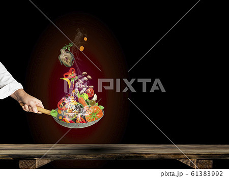 Chef  Cook Cooks Vegetables.  Healthy food in the pan on a dark gradients background. 61383992