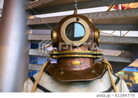 Close-up helmet Old vintage three-bolt deep-sea diving suit. Suit for deep sea diving of the last century. The history of the study of the underwater world Close-up helmet Old vintage three-bolt deep-sea diving suit. Suit for deep sea diving of the last century. The history of the study of the underwater world 61384779