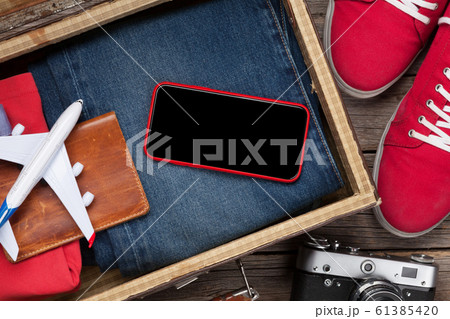 Suitcase, smartphone, clothes and travel Suitcase, smartphone, clothes and travel 61385420