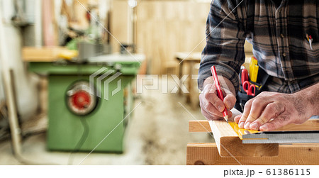 Carpenter at work on wooden boards. Carpentry. Carpenter at work on wooden boards. Carpentry. 61386115