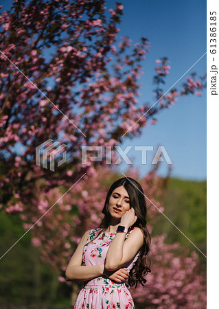 Elegant woman in beautiful dress stand outside. Gorgeous model with make up and hairstyle Elegant woman in beautiful dress stand outside. Gorgeous model with make up and hairstyle 61386185