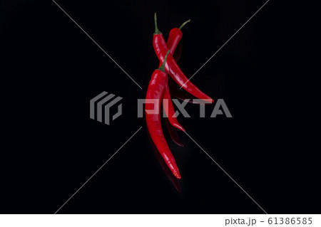 Group of red chili peppers on black background. Group of red chili peppers on black background. 61386585