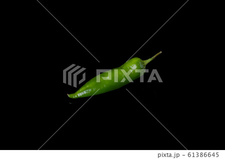 Green chili pepper on black background. 61386645