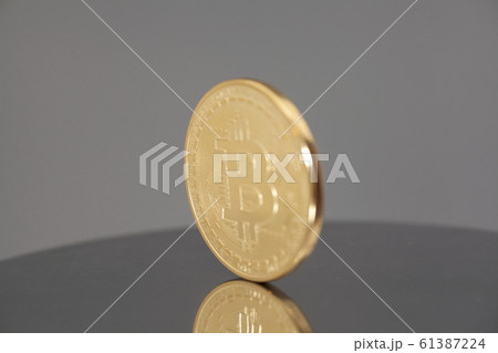 Golden Bitcoin coin on gray background Golden Bitcoin coin on gray background 61387224