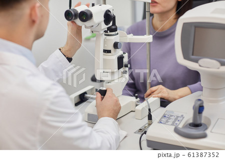 Optometrist Setting Up Equipment Optometrist Setting Up Equipment 61387352