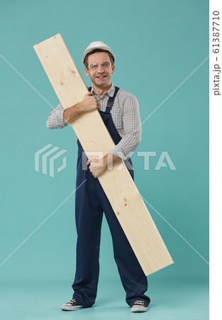 Happy Mature Worker Holding Wood Board 61387710