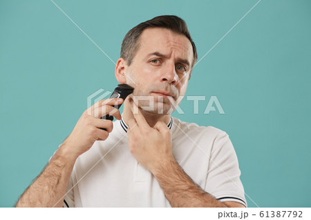 Adult Man Shaving with Electric Razor 61387792