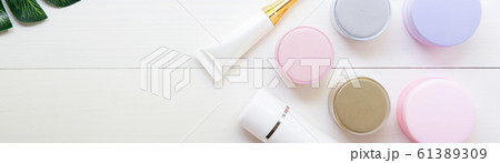 cosmetic and skin care product and green leaves on white wood table cosmetic and skin care product and green leaves on white wood table 61389309