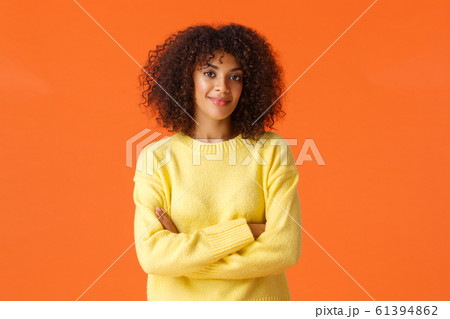 Waist-up portrait lovely young african-american female in yellow cute sweater, wrap hands around herself, cross hands on chest and smiling, give knowing look, express professionalism and confidence 61394862