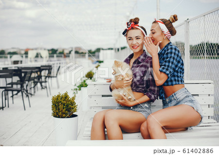 Stylish pin up girls with the little dog Stylish pin up girls with the little dog 61402886