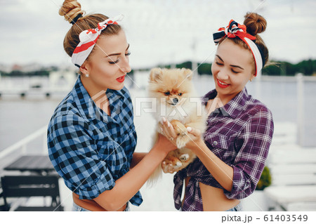 Stylish pin up girls with the little dog Stylish pin up girls with the little dog 61403549