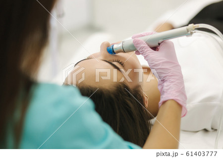 First-person view of cosmetologist doing beauty procedure at cosmetology clinic First-person view of cosmetologist doing beauty procedure at cosmetology clinic 61403777