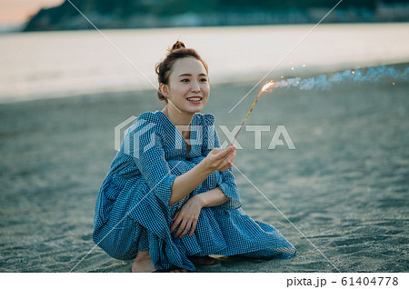 海で花火をする女性 61404778
