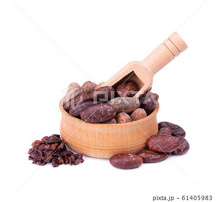 Peeled cocoa beans in the wooden bowl, isolated on white background. Roasted and aromatic cocoa beans in wooden spoon, natural chocolate. 61405983