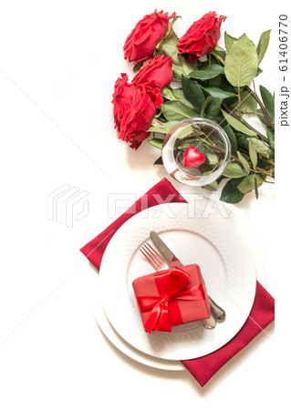 Romantic table setting with bouquet of red roses 61406770