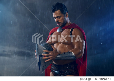 Muscular wet spartan in red cloak. 61409871