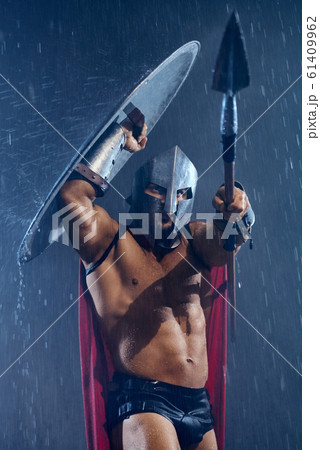 Spartan hiding from rain under shield. Spartan hiding from rain under shield. 61409962