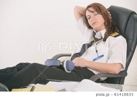 Woman airline pilot sleeping in the office 61410635
