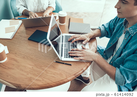 Young man is using laptop in office 61414092