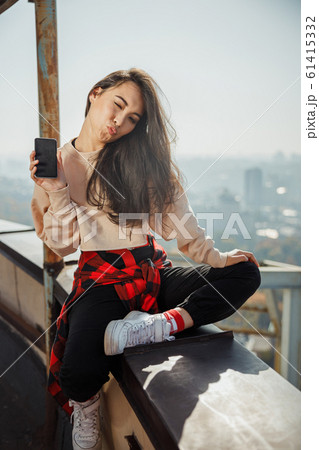 Happy pretty girl winking at the camera Happy pretty girl winking at the camera 61415332