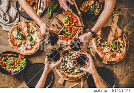 People clinking glasses with wine over table with 61415477