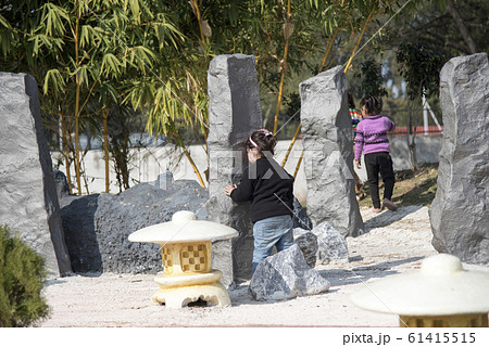 Children playing hide and seek outdoors in Japanese Garden, Chandigarh, India. 61415515