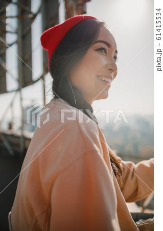 Happy pretty girl sitting on the roof 61415534