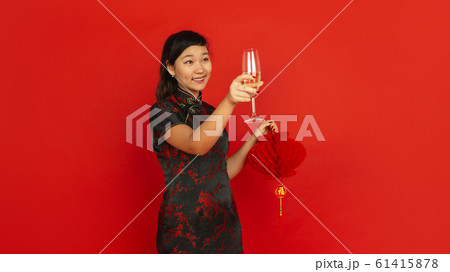 Happy Chinese New Year. Asian young girls's portrait isolated on red background Happy Chinese New Year. Asian young girls's portrait isolated on red background 61415878