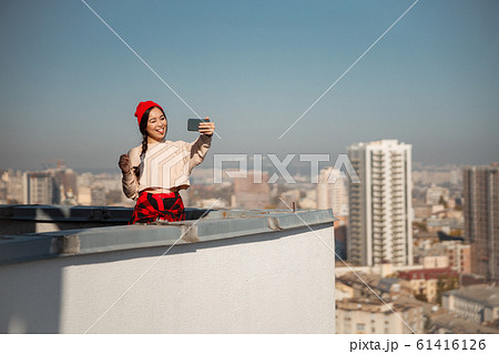 Smiling pretty lady making selfie on roof Smiling pretty lady making selfie on roof 61416126