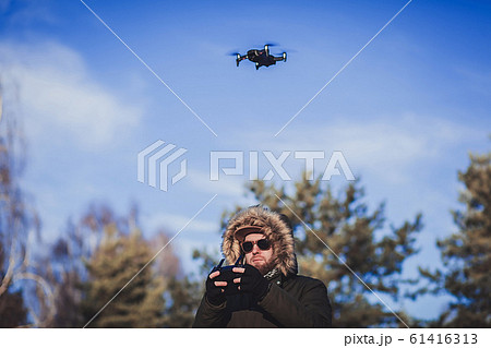 Bearded man playing with the drone Bearded man playing with the drone 61416313