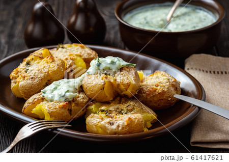 Crispy smashed potatoes roasted with garlic and parmesan.  61417621