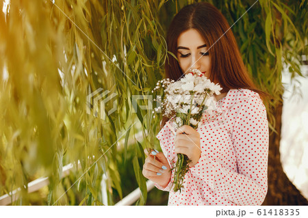 Cute girl walking in a summer park Cute girl walking in a summer park 61418335