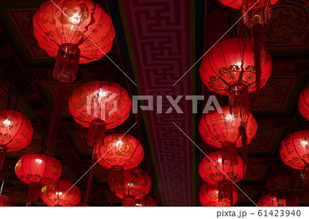 Many illuminated red Chinese lanterns with some Chinese characters on it 61423940