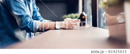Man using smartphone, During leisure time. 61425015