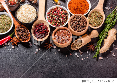 Spices and herbs over black stone background Spices and herbs over black stone background 61427817
