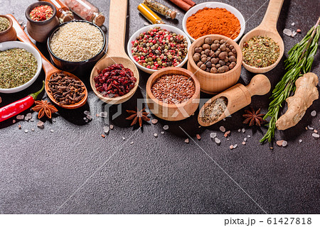Spices and herbs over black stone background Spices and herbs over black stone background 61427818